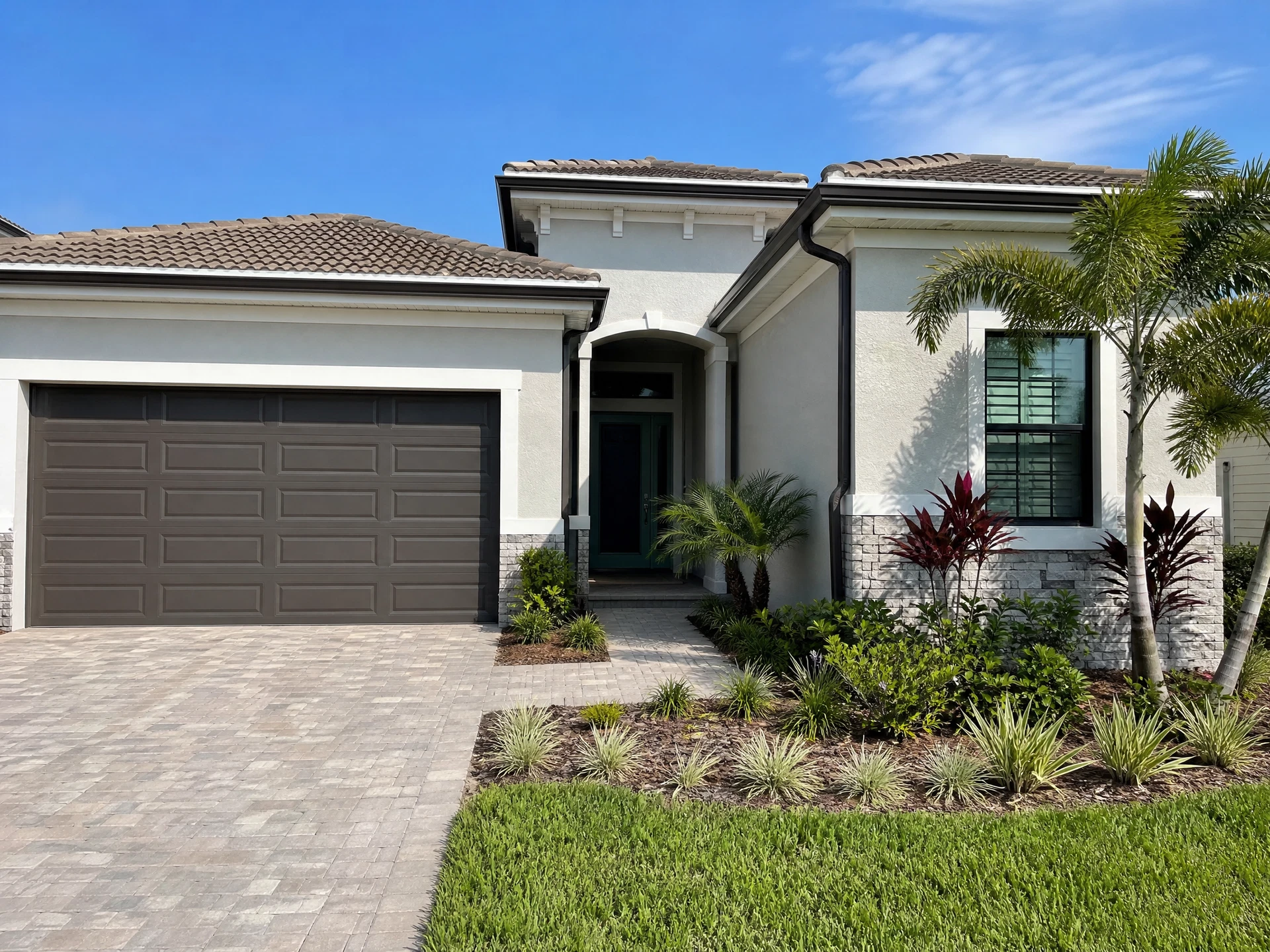 Temporary replacement image showing the front exterior elevation, driveway, windows, doors, and garage of a Florida home